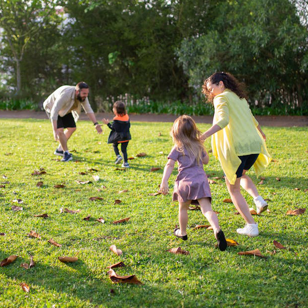 A happy and healthy family playing in the park in Santa Clarita, CA